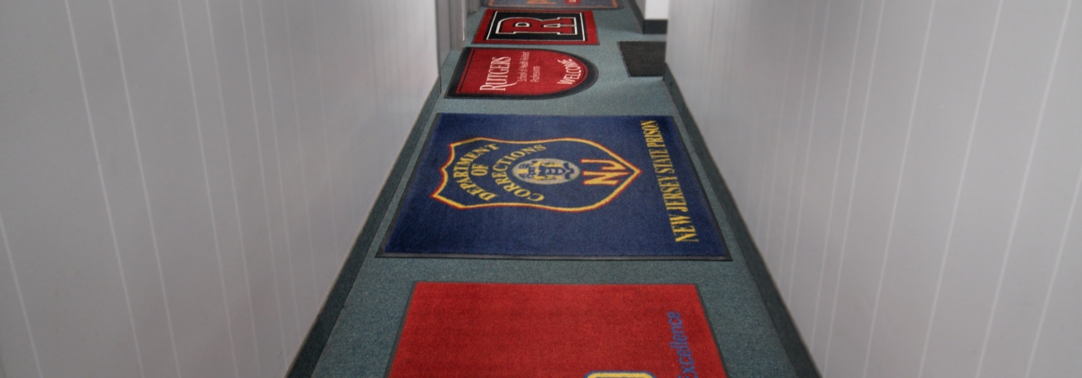 https://www.ndcmats.com/wp-content/uploads/2021/05/custom-floor-mats-1210x423.jpg